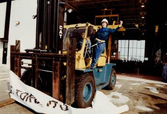 It's Open: Betty Disero rides a forklift truck through a banner to officially open the first new building in the working area of the port in the past 20 years