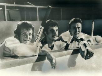 Gary Dolson takes a breather (above) between Leaf captain Sittler (left) and Salming, and is checked (right) by Maloney