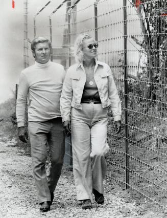 Durish and wife Carole Ann walk along the 8-foot tall fence which surrounds Klahanie