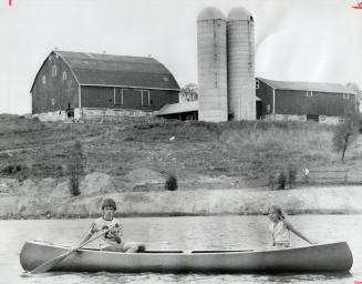 Canoeing on man-made lake in the sanctuary, Ken Durish, 12, and Linda Durish, 10, nephew and niece of Paul Durish, pass the barn which will be convert(...)