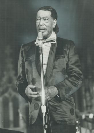 A red shirt and white jacket draped Duke Ellington when he appeared in fornt of 3,000 people at St