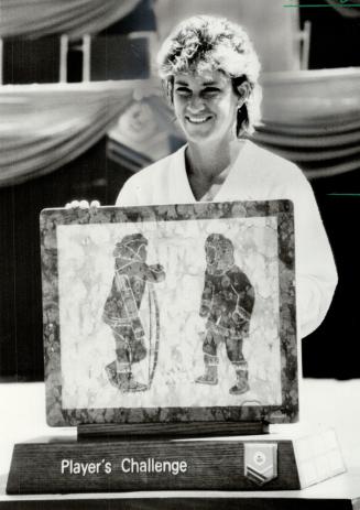 Getting to be a habit. Chris Evert Lloyd was presented with Inuit art symbolizing victory in the Canadian Open yesterday following her easy win over Claudia Kohde-Kilsch