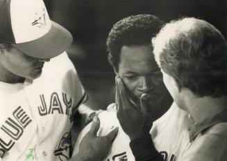 Ouch! Tony Fernandez gets help from trainer Tommy Craig after the shortstop banged his head in an eighth-inning collision with Kelly Gruber
