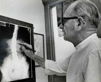 Douglas Firth, a Toronto osteopath, studies an x-ray