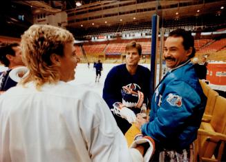 Money talks: And there's no shortage of conversation as Edmonton's Bernie Nicholls, left, and Craig Simpson chat with Leaf netminder Grant Fuhr yesterday
