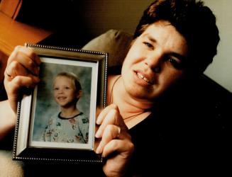 Mother holding picture of boy