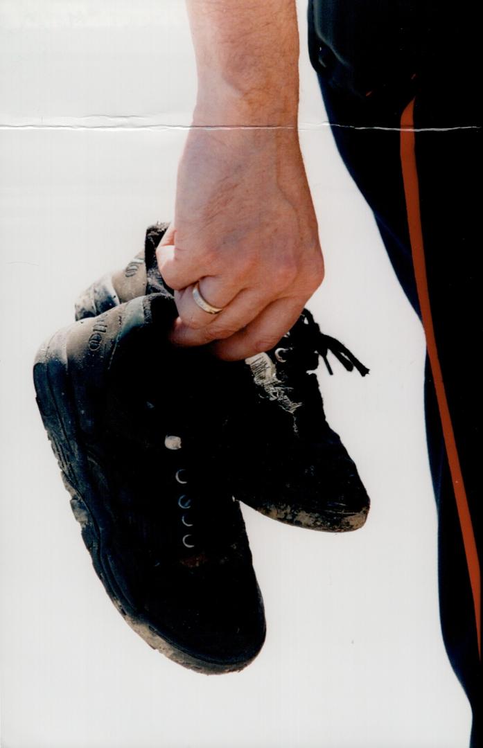 Man holding children's shoes