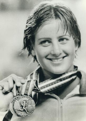 Silver smile. Nancy Garapick proudly displayed her two Pan Am Games silver medals, one in 200-metre medley and other in 4x100-metre medley relay
