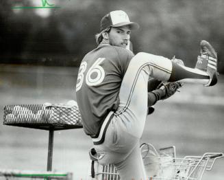 Practise makes imperfect: Blue Jays relief pitcher Jerry Garvin goes through a whole shopping cart of baseballs as he works on his feared (by Blue Jays) home run pitch