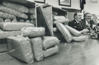 RCMP Superintendent Ken St. Clair and Bob Burfield of Canada Customs yesterday display some of the 4,550 kilograms (10,000 pounds) of hash seized from(...)