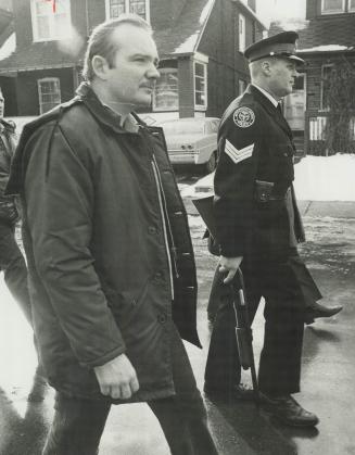 Carrying Shotguns, police officers join in search for suspect in fatal shooting of Metro Constable Leslie Maitland today. Maitland was shot in the Dan(...)