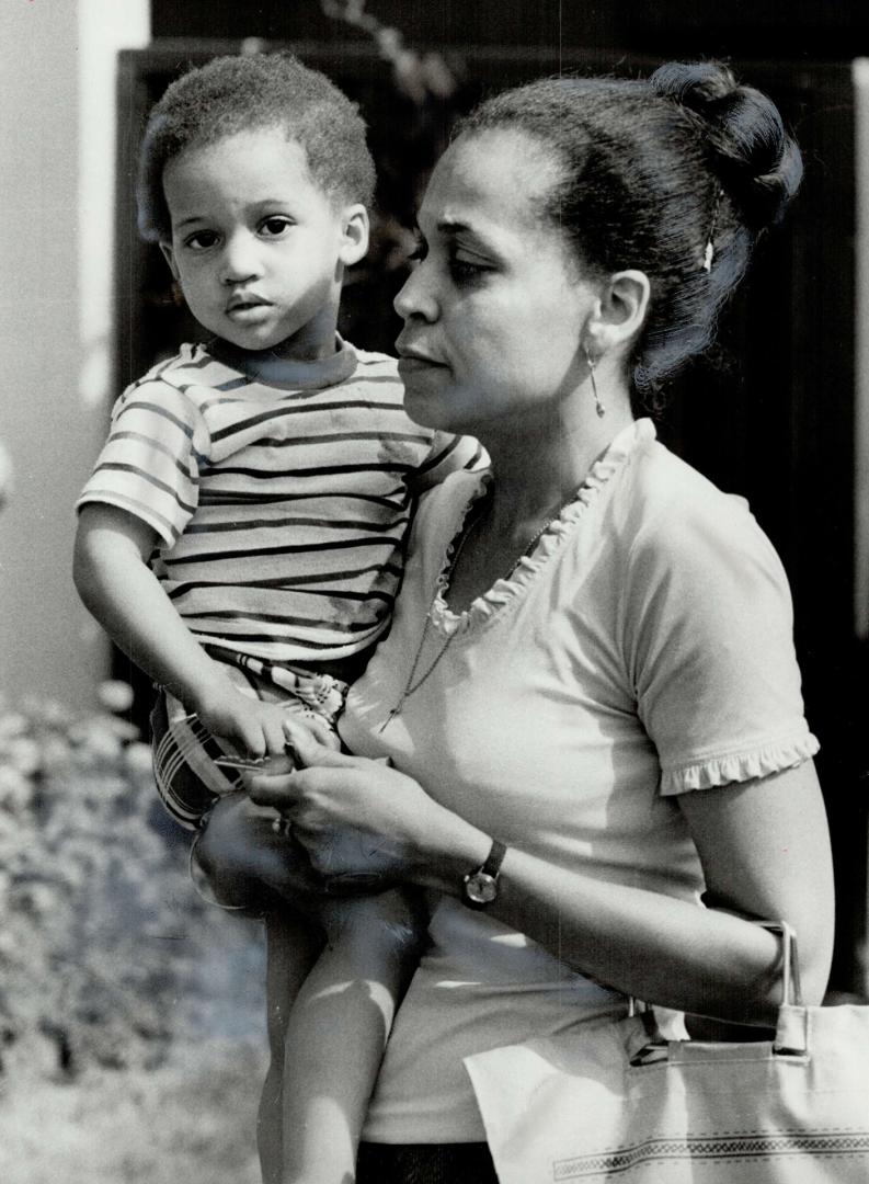 Kimberly Hunte, 2, is carried home by her mother, Joan