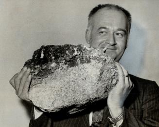 55-Pound Boulder used in the slaying of 10-year-old Gilles Leblanc, is lifted by detective David Duncan, of Hull