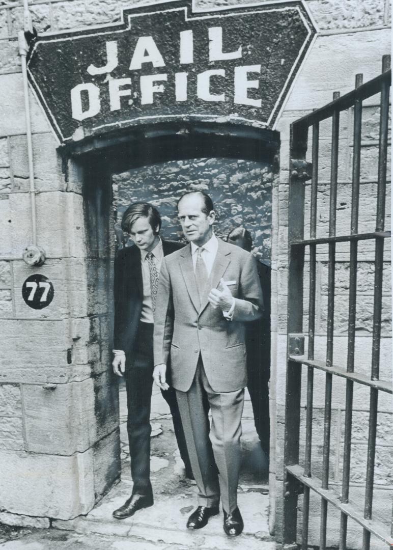 Prince Philip goes to jail, Escorted by Bruce MacLock, national director of Canadian Youth Hostels, Prince Philip (right) emerges from Ottawa's centur(...)