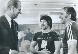 Prince Philip shares a laugh with Australian wrestler Ray Barry, middle, and his coach, Sam Parker
