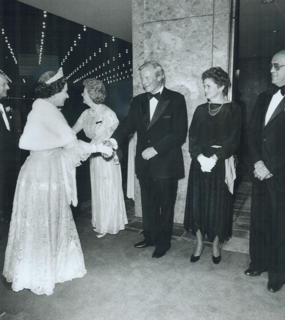 Ontario dinner: Premier William Davis and his wife Kathleen greet the Queen as she arrives for the Ontario bicentennial dinner at the Hilton Harbor Castle Hotel