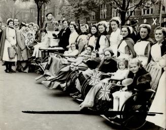 The King and Queen of story books live now for these invalid youngsters, who, unable to walk, were wheeled out to join the cheering thousands of other children who lined the royal route in Toronto