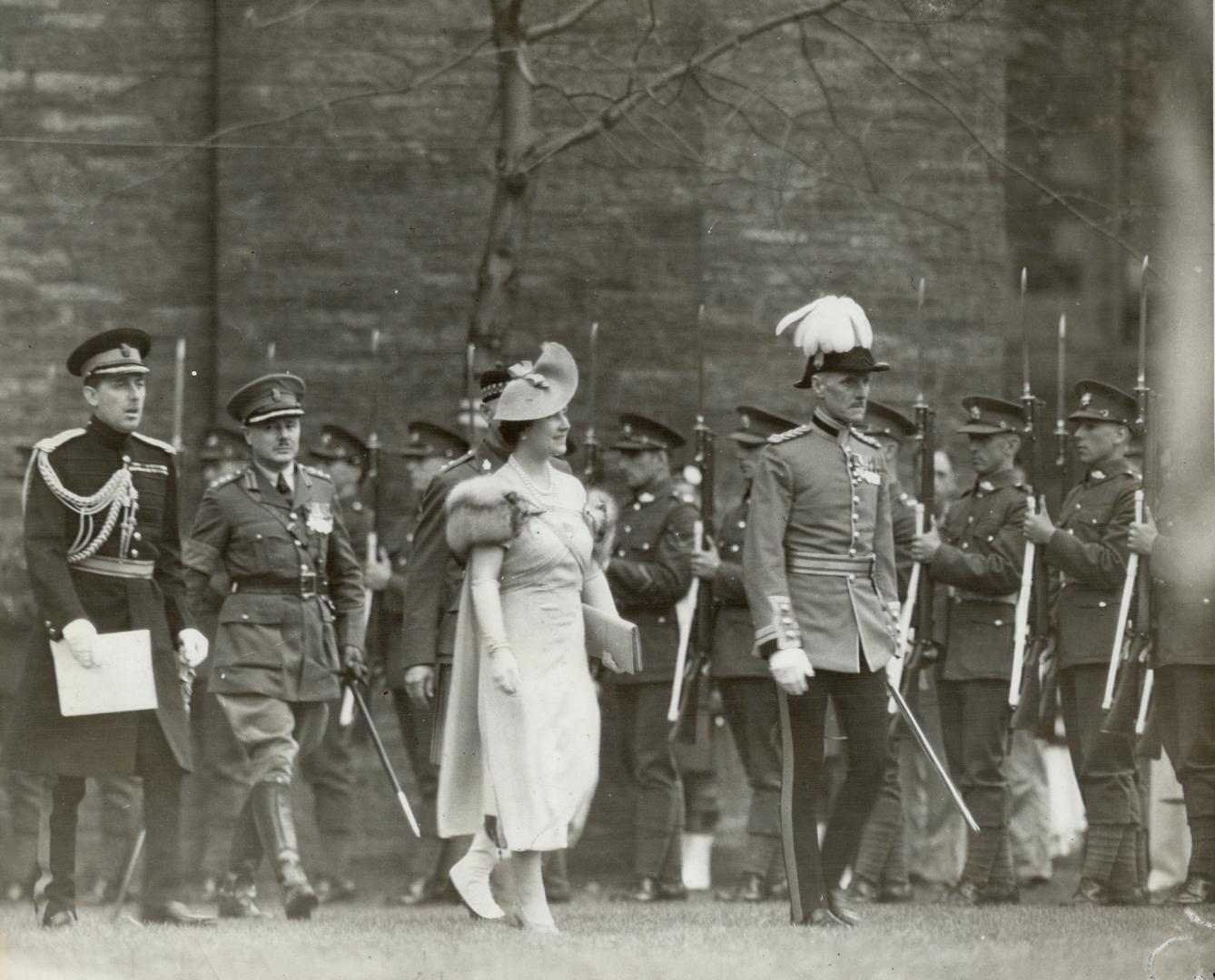 Escorted by brigadier R. O. Alexander, the Queen goes to present colors to her regiment, Toronto Scottish