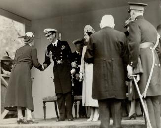 The King and Queen are seen greeting guests at the garden party given in ther honor by Vice-Admiral Sir Humphrey Walwyn, at Government House. His majesty wore the uniform of an admiral