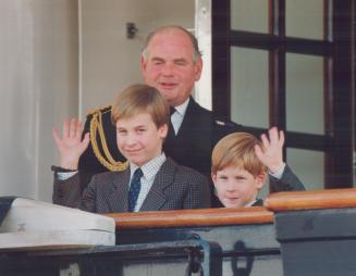Prince William, 9, and Prince Harry, 7, wave after arriving at the royal yacht Britannia yesterday, watched over by the vessel's captain, Rear Admiral Robert Woodard