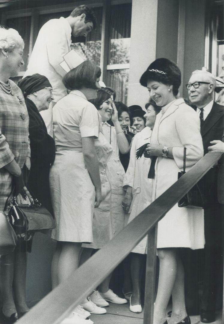 Taking her leave of the hospital named after her, Princess Margaret finds the time to talk with nurses on the steps