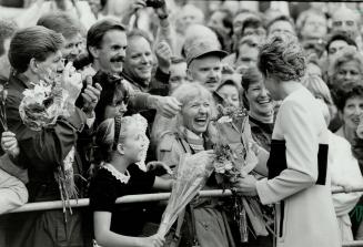Friendly Faces: Bouquets from young and old are the order of the day as Diana, Princess of Wales, greets some of the 5,000 people in Nathan Phillips Square yesterday