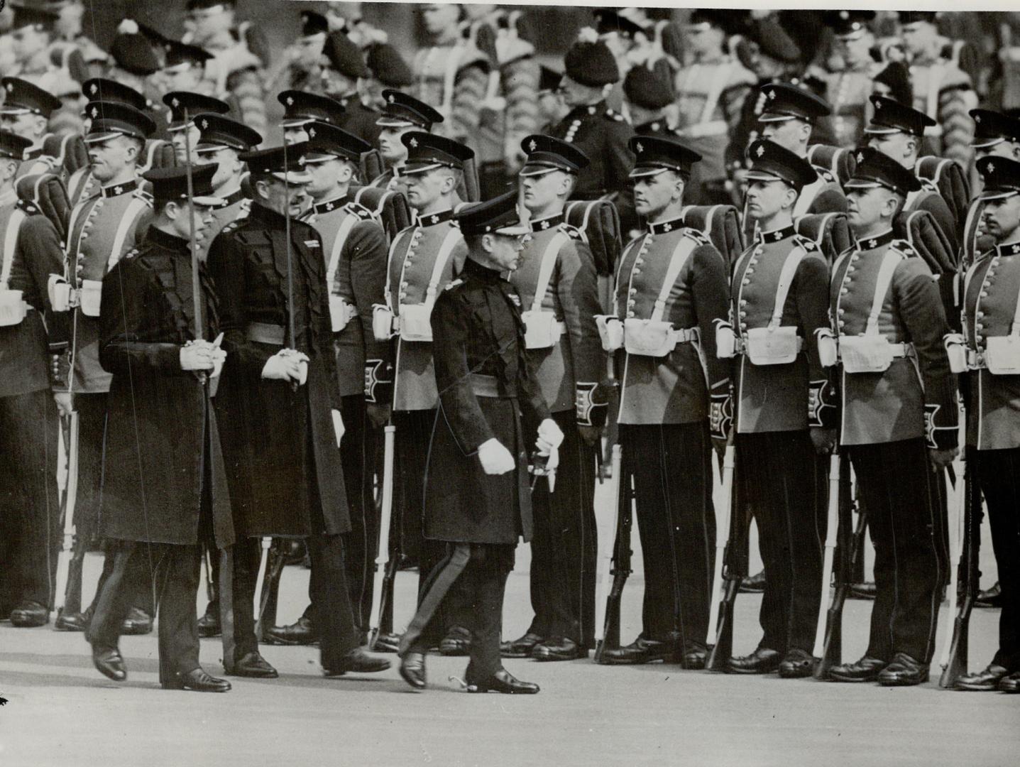 The King inspects Irish guards- Followed by officers of the battalion the King is shown here as he inspected the 1st Battalion of the Irish Guards at Chelsea barracks, London, England