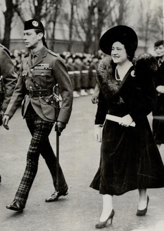 Aldershot, England - King George VI and his smiling Queen walk to the parade grounds to take the salute after attending divine service at the newly en(...)