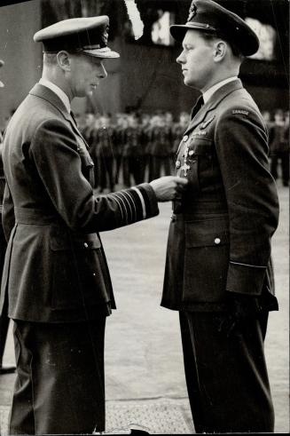 The King presents the Distinguished Flying Cross to Flying Officer G