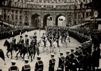 An excellent view of mounted in their colorful dress uniforms and carrying gleaming lances, passing un rafargar Square for the coron section of the [Incomplete]