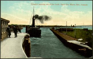 A large boat surmounted by a black cloud moves away from the camera, out the locks and into the ...