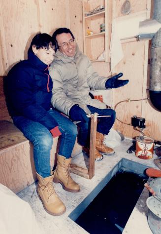 Swapping fish stories? Conservative leader Larry Grossman and son Jamie, 12, kick off the ice fishing season at Jackson's Point in a hut on Lake Simco(...)