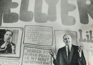 Running as a liberal in 1968, Paul Hellyer campaigns beside a poster of Pierre Trudeau