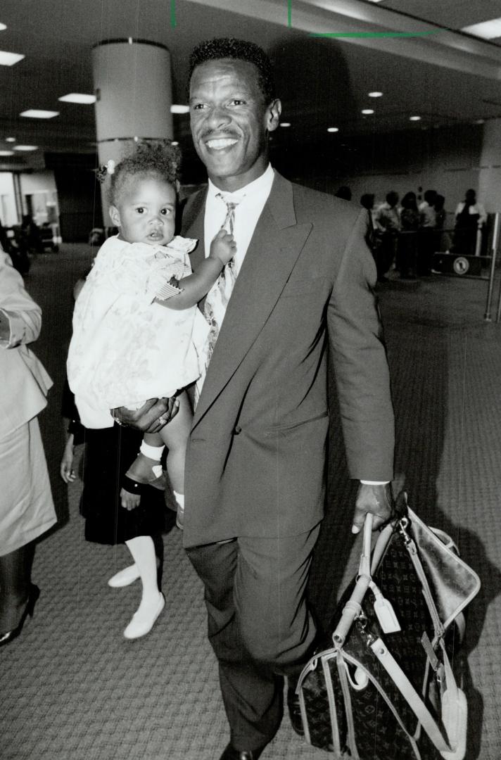 Oakland A's star Rickey Henderson carries daughter Alexis, 13 months,  through Pearson airport last night – All Items – Digital Archive Ontario