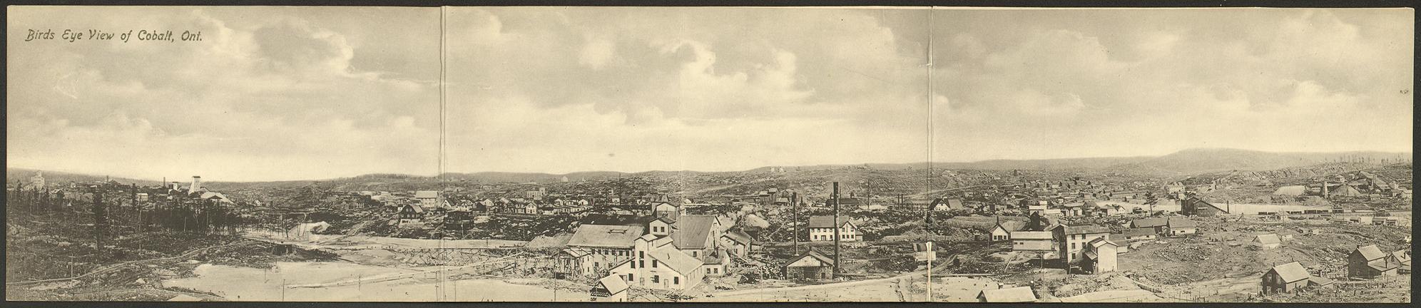 Black and white panoramic view of a large mining town.