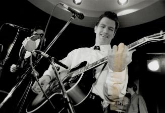 Chart topper opens store: San Francisco guitar crooner Chris Isaak entertains a lunch hour crowd yesterday at the new HMV 333 music store just north of the Eaton Centre at Yonge and Dundas Sts