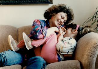 Tickle time, Patti Jannetta plays with daughter Ashley, 3, at her Mississauga home
