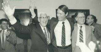 V for victory: East York Mayor Dave Johnson, right, is congratulated on his easy second-term win in yesterday's election by former borough alderman Stan Wadlow