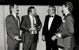 Happy moment: Wayne Burns, left, and Steve Wills of Bernard Hodes and Andy Day, right, receive Gold Star awards from Toronto Star publisher David Jolley