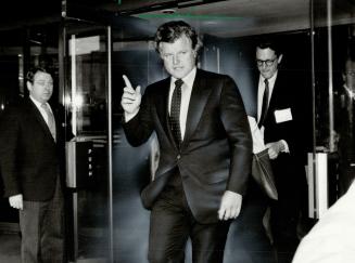 Going home: Senator Ted Kennedy raises a finger to acknowledge photographers as he leaves the Royal York Hotel today after speaking to a bricklayers' union convention