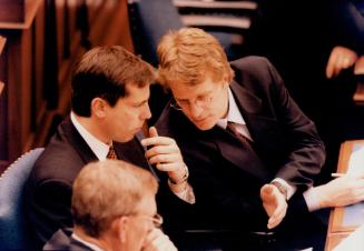 Hand signals: Liberal MPP Gerard Kennedy, right, gestures as he discusses PC budget with Liberal Leader Dalton McGuinty yesterday