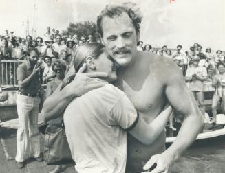 CNE lake swim victor John Kinsella is hugged by finance Christine Kalber