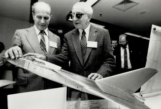 Sharing memories: Test pilots Jan Zurakowski, left, and Wladyslaw (Spud) Potocki examine a model of the Avro Arrow