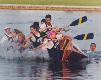 Making a big splash. The crew from Marc Garneau Collegiate take an unplanned dip in Lake Ontario yesterday as their canoe overturns just a few metres (...)