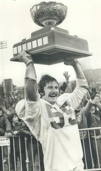Captain Duncan MacKinley hoists the College Bowl trophy aloft