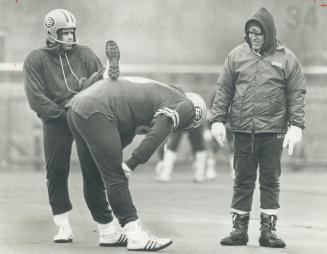 Edmonton quarterback Tom Wilkinson borrowed a teammate's back for a footstool while absorbing advice from Don Matthews