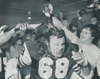 Angelo Mosca Retires in style. Ticat tackle Angelo Moscais drenched in champagne by defensive back John Williams (left) and defensive end Gary Inskeep(...)