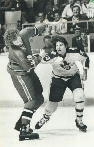 Violence on ice: Maple Leafs' Dave Hutchison lands a mean right fist to the jaw of Montreal Canadien Larry Robinson during a game in the mid-'70s, when violence was at its height in NHL