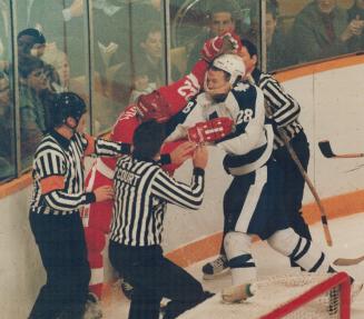 In this Corner....Dave Barr of Detroit Red Wings tangles along the boards with Maple Leafs heavy Brian Curran (28) in a game that had a bit of everyth(...)