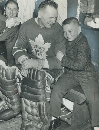 Johnny Bower, 9, is proudest and happiest lad in town as he poses with pop after game